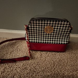 Beautiful black, white, and red purse with gold accents